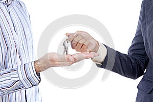 Hand giving a key isolated
