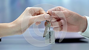 Hand giving key to fortune, secret of raising money, successful business, dream