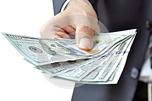 Hand giving money - United States Dollars (USD) bills