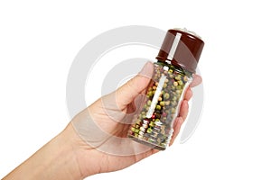 Hand with glass pepper mill isolated on white background, hot and spicy flavor