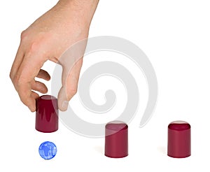 Hand and globe shell game