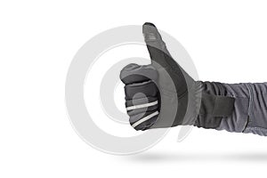 Hand in a glove of a cyclist or motorcyclist. Hand in black glove  on white background showing thumb up or