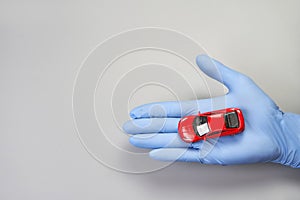 Hand in glove defend toy car. Safety anti virus concept