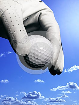 Hand with glove and golfball