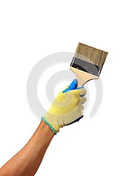 Hand in a glove is holding a brush isolated on white background