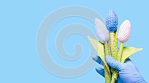 Hand in a glove holding flowers fabric. Anti-allergic