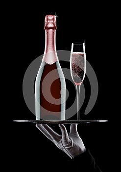 Hand with glove holds tray with champagne glasses