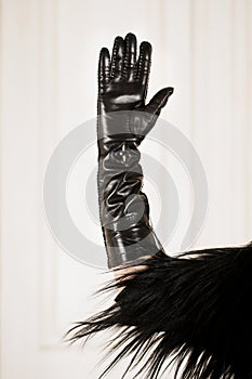 Hand in glove on a light background, close-up