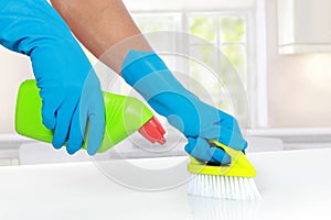 Hand with glove using cleaning brush to clean up