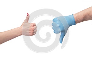 Hand in gloves thumb down and without thumb up over white background