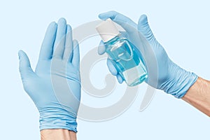 Hand with gloves uses an alcohol-based liquid sanitizer that kills most types of microbes and viruses. Covid and