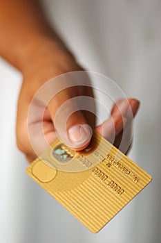 Hand With a Gold Credit Card