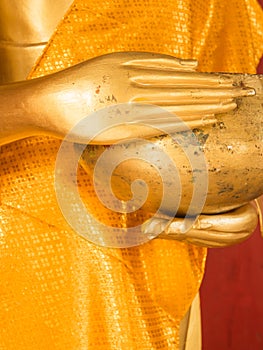 Hand of Golden Buddha Statue with begging bowl in Thailand Buddhist Temple