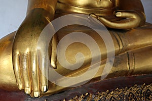 Hand of Golden Buddha statue stucco in different posture in long corridor of Wat Phra Temple, Bangkok, Thailand