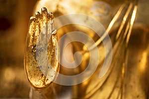 Hand of a golden Monday Buddha statue