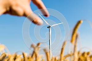 Hand grabbing the blade of a wind turbine