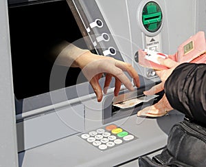 Hand grabbing cash machine