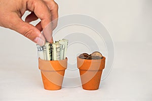 Hand grabbing money in a terracotta pot