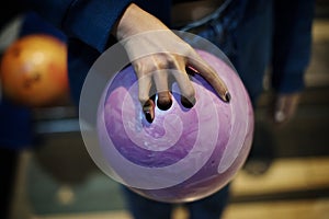 Hand Grabbing the pink bowling ball