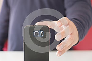 Hand grasping a smartphone