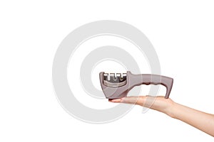 Hand with gray knife sharpener with handle, kitchen utensil