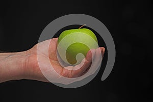 Hand with green apple