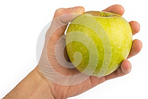 In a hand a green apple isolated on a white background
