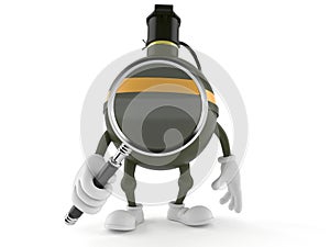 Hand grenade character looking through magnifying glass