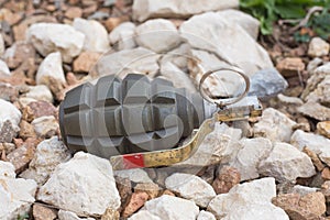 Hand grenade lying on the stones