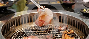 Hand Grilling meat pork on stove serve in restaurant. Japanese food and Korean BBQ traditional style