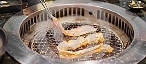 Hand Grilling meat pork on stove serve in restaurant. Japanese food and Korean BBQ traditional style
