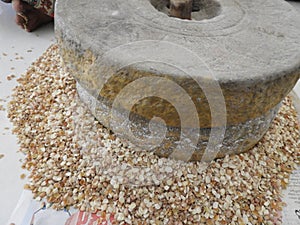 Hand grinding cow peas with millstone in Indian house