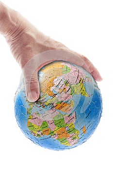 Hand gripping globe photo