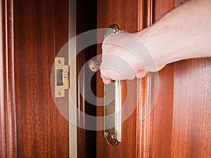 Hand gripping the handle of a door