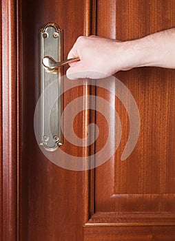 Hand gripping the handle of a door