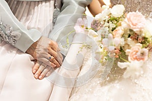 Hand of groom`s mother beside bride in wedding day
