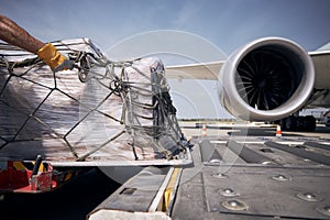 Loading of cargo containers to plane at airport