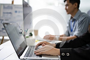 Hand of a group of employees working in the office. They are working on the computer