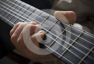 Hand on guitar fingerboard photo