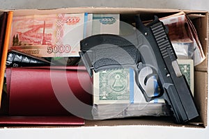 A hand Gun, Passport and Money set on a white background base