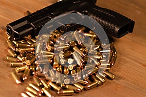 Hand gun on a pile of bullets