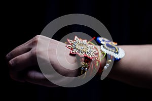 hand of a guy with rakhi tied in wrist in the occasion of rakshabandhan