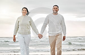 Hand in hand. an affectionate young couple sharing an intimate moment on the beach.