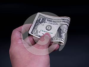 Hand handing over money. Businessman with money in hand. US dollar USD bills. Investment, success and profitable business