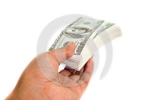 A hand handing over stack of one hundred dollar bills on white b
