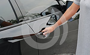 Hand on handle to open car door