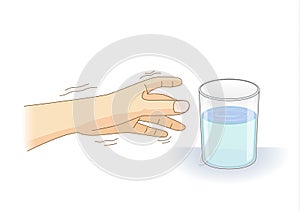 A Hand have tremor symptom reaching out for a glass of water. photo