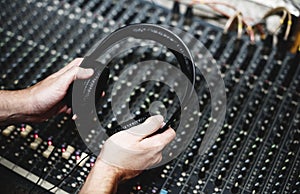Hand with headphone on sound mixer