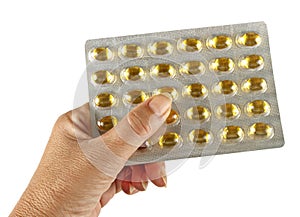 Hand with healthy omega oil capsules, isolated