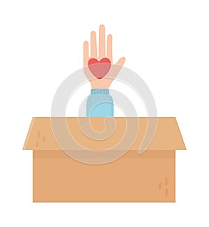 Hand with heart in cardboard box charity and donation concept